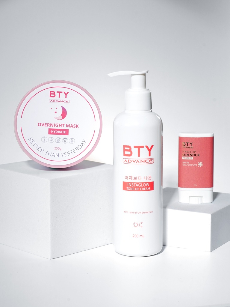BTY Advance Overnight Mask, Instaglow, and Sun Stick on a desk with stacked books