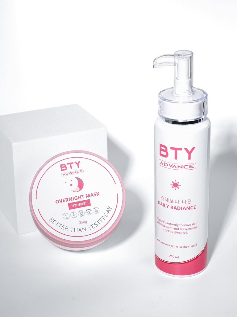 BTY Advance Daily Radiance and Overnight Mask on a wooden desk with office supplies