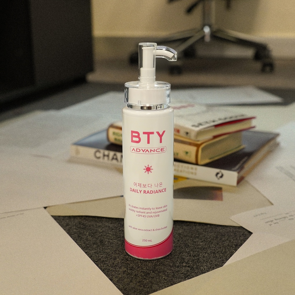 BTY Advance Daily Radiance on a stack of books