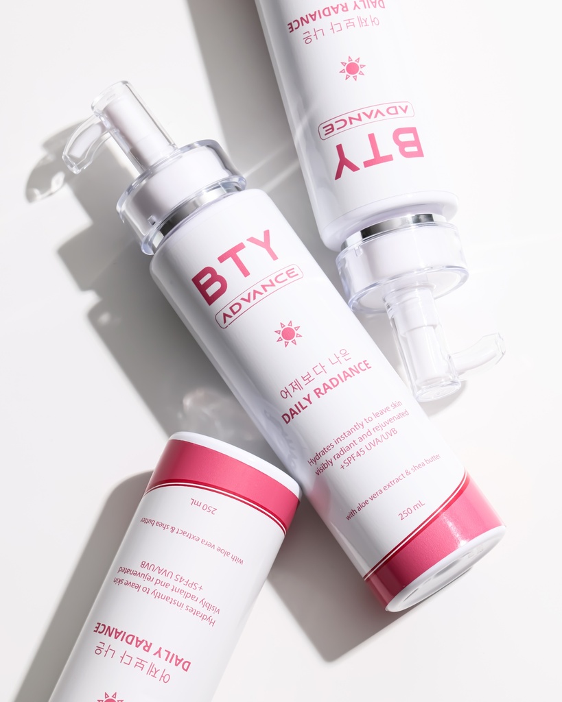 BTY Advance Daily Radiance on a stack of books