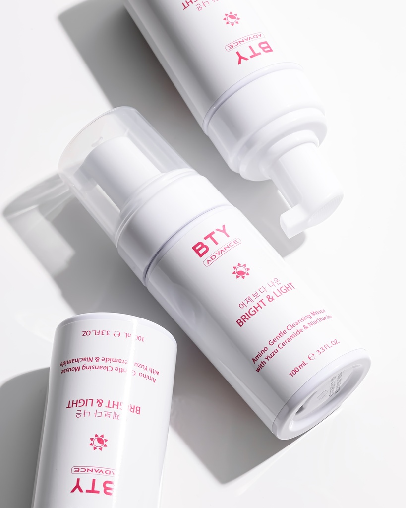 BTY Advance Bright & Light Cleanser on a dark table with a city view
