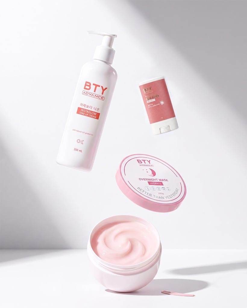 BTY Advance Instaglow, Overnight Mask, and Sun Stick on a dark table with a city view